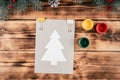 Step-by-step Greeting card Christmas tree with children`s fingerprints tutorial. Step 4: Fix stencil with clamps Royalty Free Stock Photo