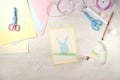 Step by step instruction: how to make card Happy easter. DIY creativity. Step 4 glue paper rabbit, grass and ears of rabbit.