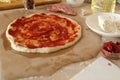 Step-by-step instructions for cooking pizza. Step 1. Roll the dough onto the dough and spread the tomato sauce. Dough with red Royalty Free Stock Photo