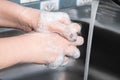 A woman washes and disinfects her hands with soap. Royalty Free Stock Photo