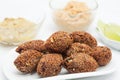 Ready fried kibbeh served with tahini and hummus