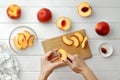 Step by step recipe galette or pie with nectarines. Female hands cut nectarines into slices for cake. Royalty Free Stock Photo