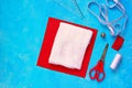 Step-by-step sewing of a protective medical gauze mask on a blue concrete background. Step one, the necessary materials. Royalty Free Stock Photo