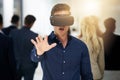 Step into a whole new world. a young businessman wearing a VR headset in a busy office. Royalty Free Stock Photo
