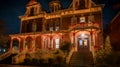 Enchanting Holiday Grandeur: Mesmerizing Nighttime Photo of Victorian Mansion\'s Decorated Entrance