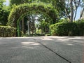 Curved Gateway With Clipped Hedge Growing Over- Scenic Garden Design Entrance