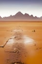 Post apocalyptic desert with puddles against mountains generated by ai