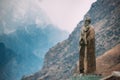 Stepantsminda, Georgia. Statue Of Alexander Kazbegi And Mountain
