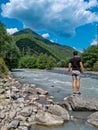Stepantsminda - A man watching the confluence of Black and White Aragvi rivers, Caucasus Mountains.