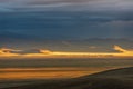 Steppe sunset mountains village sunlight rain clouds Royalty Free Stock Photo