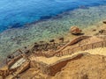 Stepped descent into the rock to the coral reef in the Red Sea