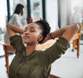 Stepping back from business for a bit. a young businesswoman taking a break at her desk.