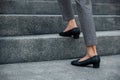 Closeup legs of businesswoman hurry up walking on stairway