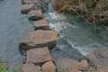 STEPPING STONES ACROSS FLOWING WATER