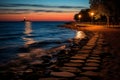 stepping stones on the beach at sunset with a lighthouse in the distance Royalty Free Stock Photo