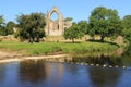 Stepping stones and Bolton Abbey with reflection