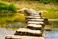 Stepping stones crossing a small river Royalty Free Stock Photo