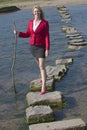 Stepping stones woman walking across river Royalty Free Stock Photo