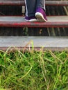 Stepping up the stairs in gym shoes and on the green grass Royalty Free Stock Photo