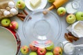 Steps of cooking apple pie. Fresh harvest apples, cinnamon, flour, sugar, butter, eggs, milk and baking mold Royalty Free Stock Photo