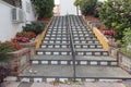 Steps decorated with ceramic tiles lead upwards through brick edged flower beds in Estepona, Spain