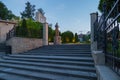 Steps with a forged fence on the way to the monument of a famous person in the town square