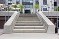 The steps of a granite staircase leading up to the wide entrance of the business center Royalty Free Stock Photo