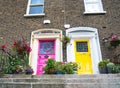 Steps lead to colorful terrace houses exterior two doors