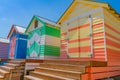 Steps leading to doors of colourful Brighton Beach Boxes on beach at Melbourne
