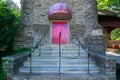 Steps Leading Up to a Red Door on a Cobblestone Church With a Welcome Sign Above the Door Royalty Free Stock Photo