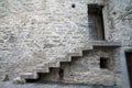 Steps leading upwards on side of wall of stone castle to opening Royalty Free Stock Photo