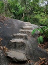 Steps made of stones in the jungle. Hiking trail for tourists