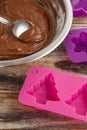 Steps of making chocolate cake: filling silicone mold with pastry