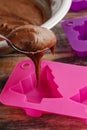 Steps of making chocolate cake: filling silicone mold with pastry