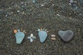 Steps of man, woman and heart made from stones on sandy beach. Royalty Free Stock Photo