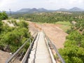 Steps to go down the hill with iron railings with mountains at the background Royalty Free Stock Photo