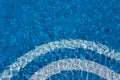 Steps to the pool, blue clear water in the outdoor swimming pool, safe descent to the pool, close-up steps through the water Royalty Free Stock Photo