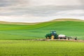 A farm tractor in the rolling wheat fields of the Palouse hills Royalty Free Stock Photo