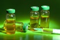 Sterile medical vials with medication solution, ampoules, and syringe on a green background