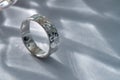 Sterling silver jewelry engagement ring on gray silk Royalty Free Stock Photo