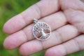 Sterling silver pendant on female hand