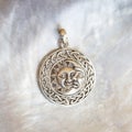 Sterling siver pendant on white shell background