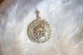 Sterling siver pendant on white shell background