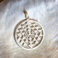 Sterling siver pendant on white shell background