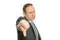 Stern, angry business man giving thumbs down Royalty Free Stock Photo