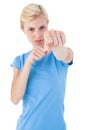 Stern blonde woman pointing with her finger