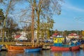 Old traditional wooden fishboat in harbor scene