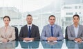 Stern business people sitting straight looking at camera Royalty Free Stock Photo