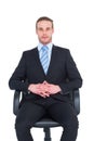 Stern businessman sitting on an office chair Royalty Free Stock Photo