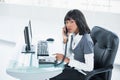 Stern classy businesswoman answering the phone Royalty Free Stock Photo